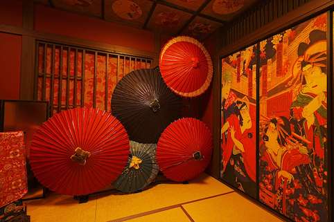 花魁和室に複数の和傘と装飾された襖があります